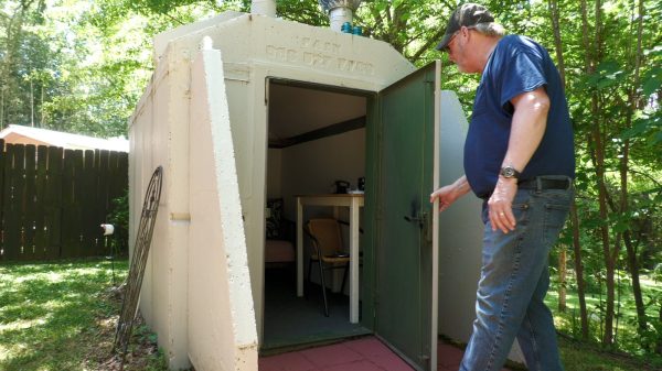 Homeowner Clint Senseman inspects his tornado shelter. Photo by Cody Farris.