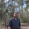 Dillon McInnis in one of the pine forests his company helps manage. Photo by Kala Nance.